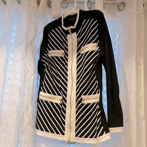Black and white jacket with gold zipper and stripes